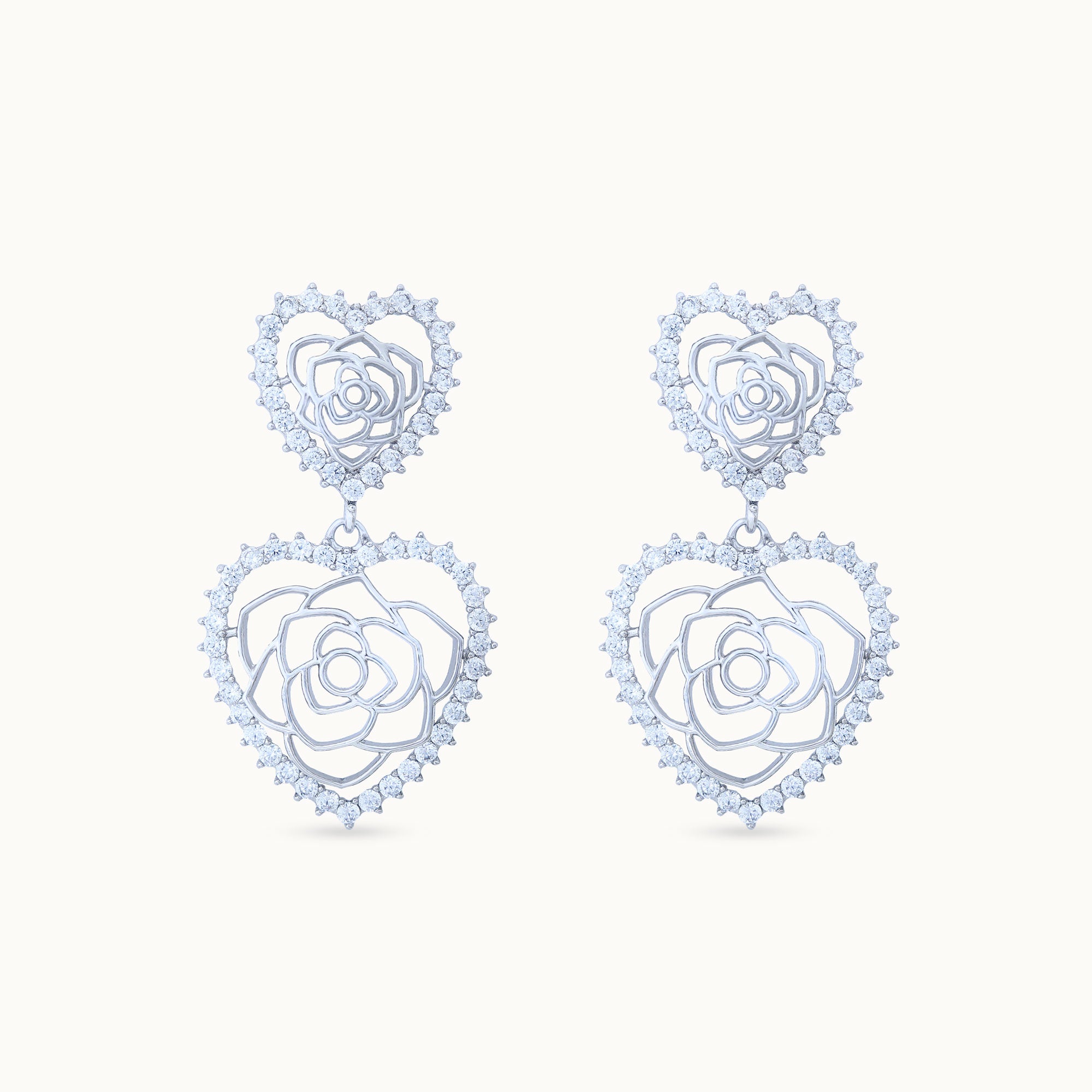 Product Close up of Elegant platinum-plated double-heart earrings with an intricate rose pattern inside, perfect for any occasion