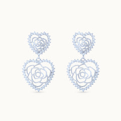 Product Close up of Elegant platinum-plated double-heart earrings with an intricate rose pattern inside, perfect for any occasion