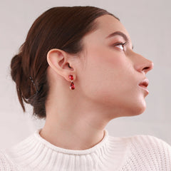 Ruby Dew Drops 18K gold-plated teardrop earrings with vibrant ruby-colored stones, perfect for daily wear and casual outings