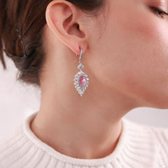 Close up of Sophia Platinum Earrings with a pink center and sparkling accents for a timeless elegant look