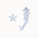 Product close up of Platinum-plated asymmetrical earrings featuring a star-shaped stud and a sleek clip-on design with a diamond-like finish, perfect for celestial elegance