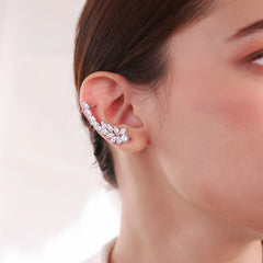 Platinum-plated asymmetrical earrings featuring a star-shaped stud and a sleek clip-on design with a diamond-like finish, perfect for celestial elegance.