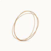 Product close up Set of three 18K gold-plated minimalist bangles with a smooth finish
