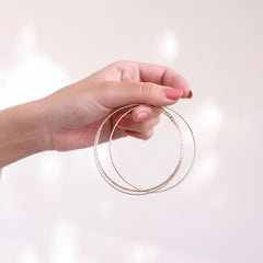 Side view of the 18K gold-plated bangles set with a simple, elegant design