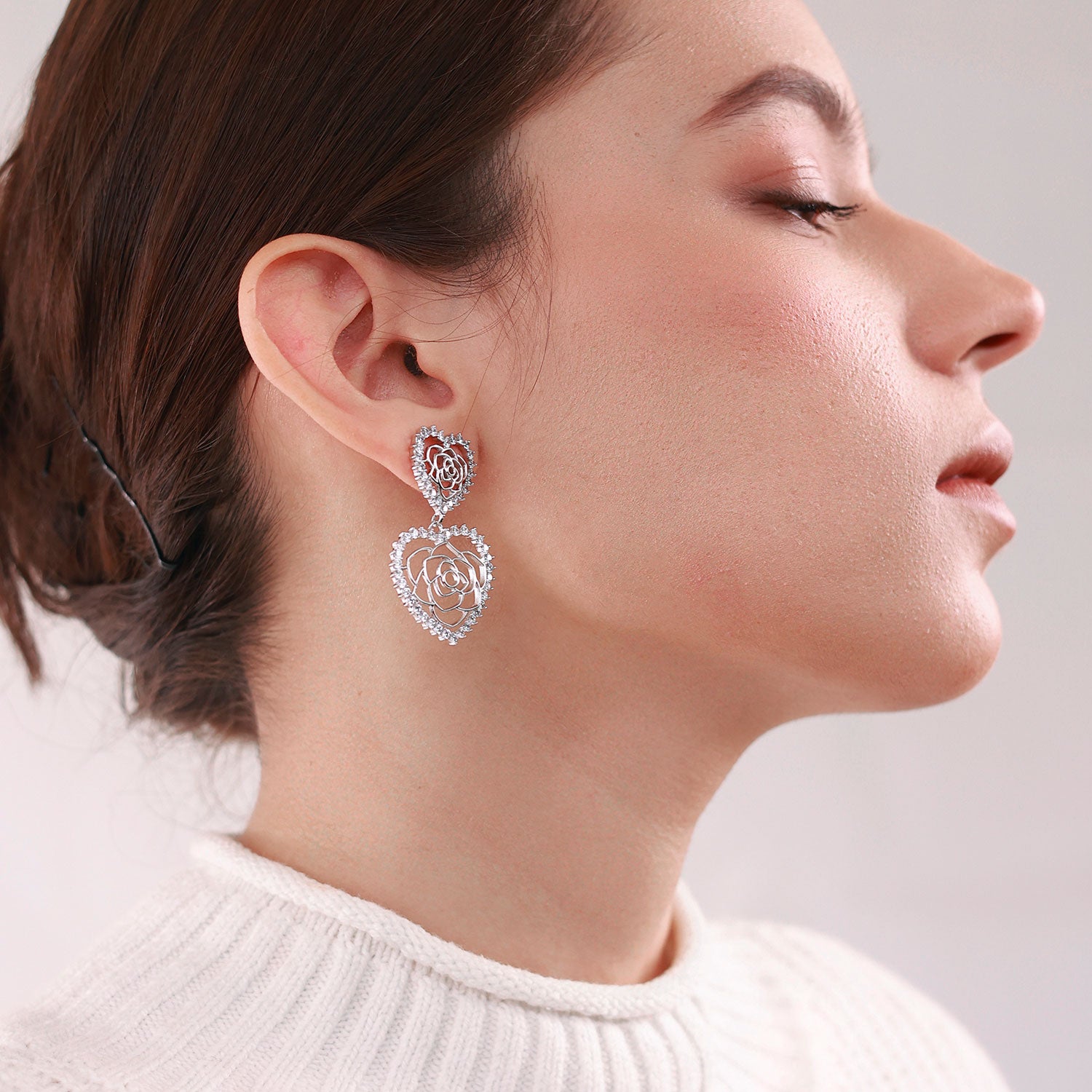 Elegant platinum-plated double-heart earrings with an intricate rose pattern inside, perfect for any occasion.